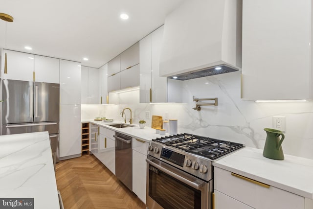 728 S Warnock St, Philadelphia, PA 19147 - kitchen featuring appliances with stainless steel finishes, a sink, custom exhaust hood, modern cabinets, and white cabinetry
