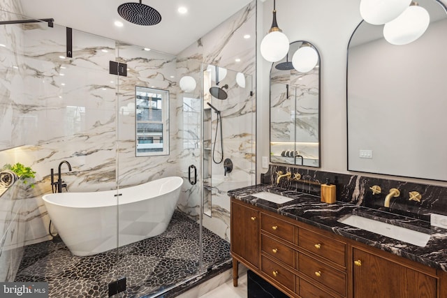 728 S Warnock St, Philadelphia, PA 19147 - bathroom featuring a marble finish shower, tile walls, a soaking tub, double vanity, and recessed lighting
