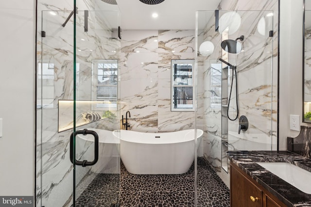 728 S Warnock St, Philadelphia, PA 19147 - full bathroom featuring a marble finish shower, tile walls, a soaking tub, vanity, and recessed lighting