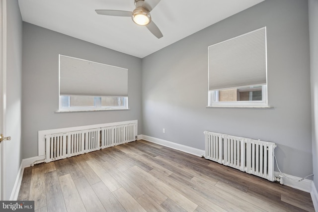 1321 Wolf St, Philadelphia, PA 19148 - spare room with radiator heating unit, radiator, ceiling fan, wood finished floors, and baseboards