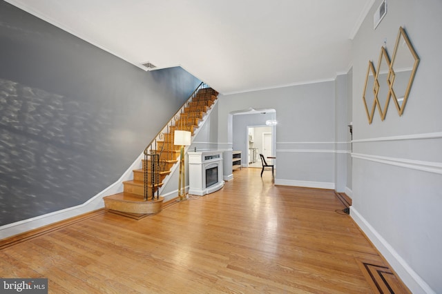 1321 Wolf St, Philadelphia, PA 19148 - interior space featuring stairway, wood finished floors, crown molding, baseboards, and arched walkways