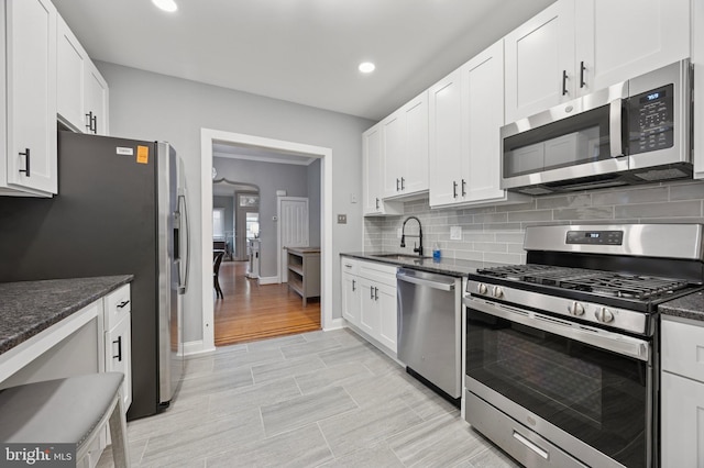 1321 Wolf St, Philadelphia, PA 19148 - kitchen with appliances with stainless steel finishes, a sink, backsplash, white cabinets, and recessed lighting