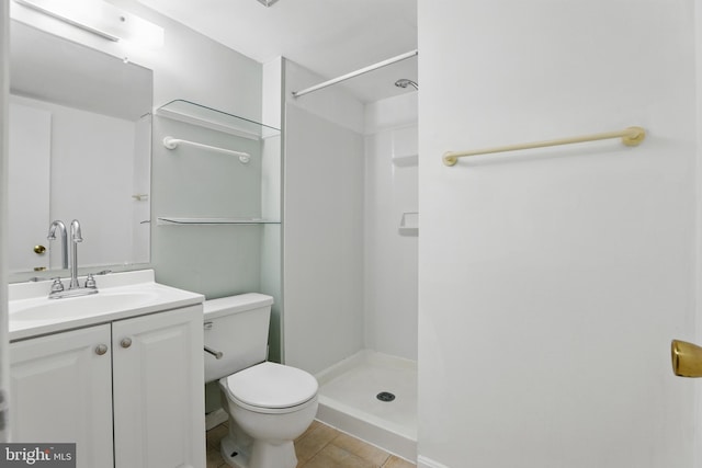 full bathroom featuring toilet, a stall shower, tile patterned floors, and vanity