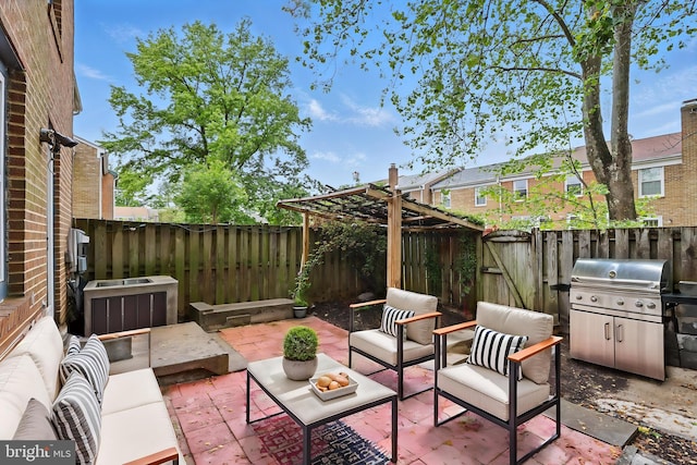 view of patio featuring outdoor lounge area, grilling area, and a fenced backyard