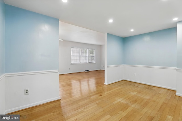 unfurnished room featuring light wood-style floors, recessed lighting, and baseboards