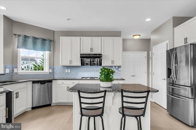 308 Galloway St, Middletown, DE 19709 - kitchen featuring appliances with stainless steel finishes, light wood-style flooring, dark stone countertops, white cabinetry, and recessed lighting