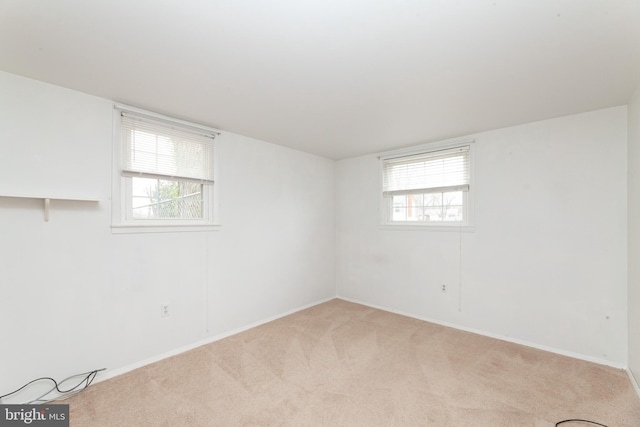unfurnished room with carpet, healthy amount of natural light, and baseboards