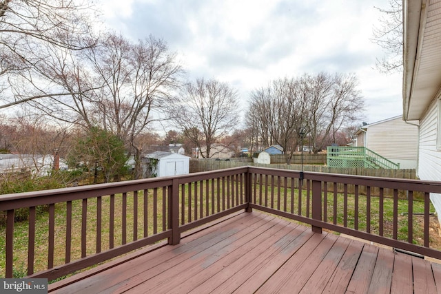 wooden deck with a shed and an outdoor structure