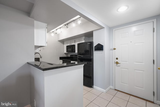 2400 Clarendon Blvd Unit 916, Arlington, VA 22201 - kitchen with black appliances, light tile patterned floors, track lighting, white cabinetry, and a peninsula