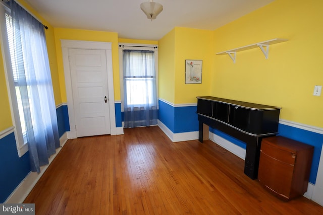 entryway with baseboards and wood finished floors