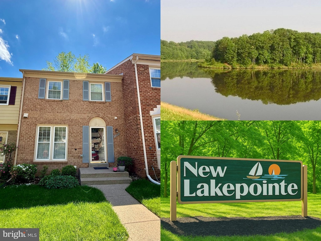 view of front of home featuring brick siding, a water view, and a front lawn