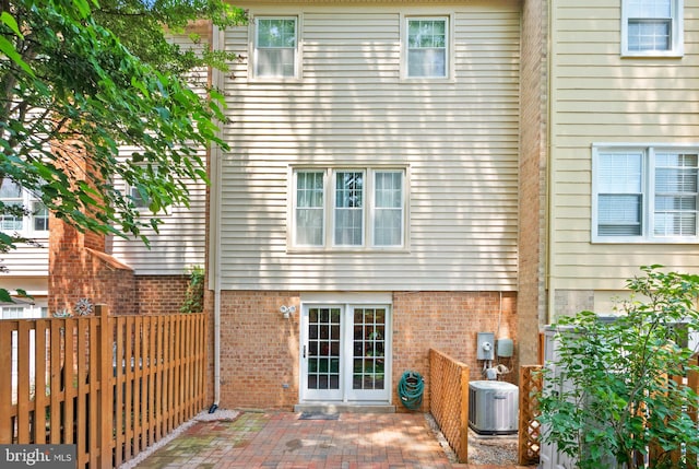 9882 High Water Ct, Burke, VA 22015 - rear view of house featuring cooling unit, a patio area, a fenced backyard, and brick siding