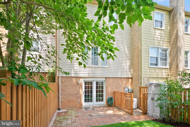 9882 High Water Ct, Burke, VA 22015 - back of property with brick siding and a patio