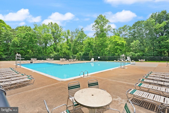 9882 High Water Ct, Burke, VA 22015 - community pool featuring a patio and view of scattered trees