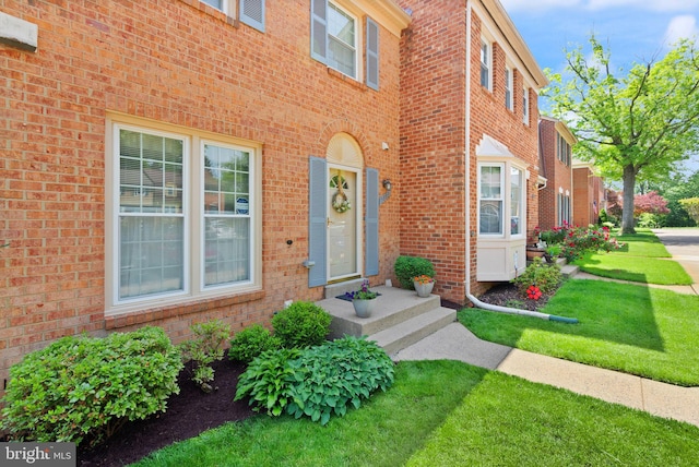 9882 High Water Ct, Burke, VA 22015 - doorway to property featuring a yard and brick siding