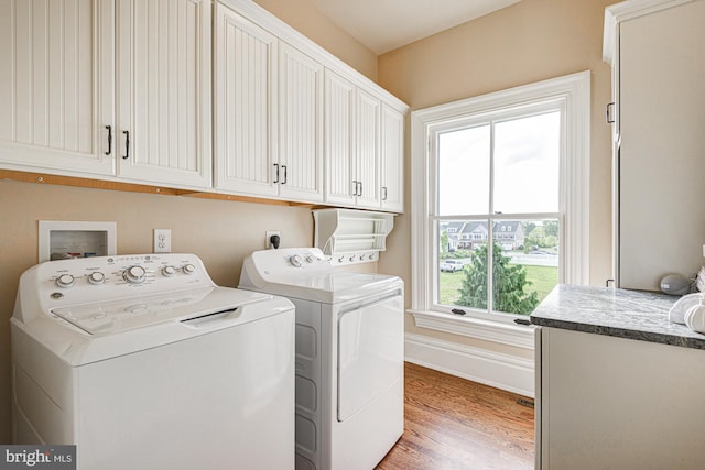 1303 Officers Row, Delaware City, DE 19706 - laundry room featuring cabinet space, washer and dryer, light wood-style flooring, and baseboards