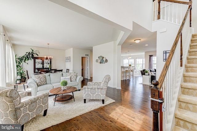1303 Officers Row, Delaware City, DE 19706 - living area with a chandelier, wood finished floors, stairway, and baseboards