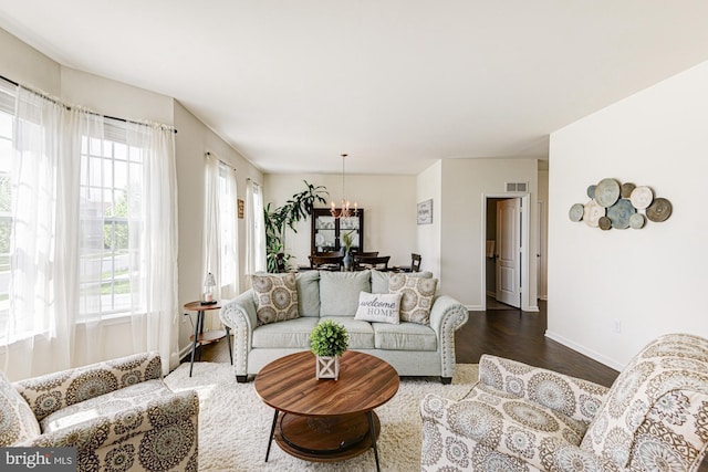1303 Officers Row, Delaware City, DE 19706 - living room with plenty of natural light, dark wood-type flooring, a chandelier, and baseboards