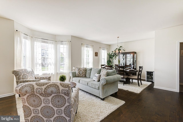 1303 Officers Row, Delaware City, DE 19706 - living area featuring dark wood-style floors, baseboards, and plenty of natural light