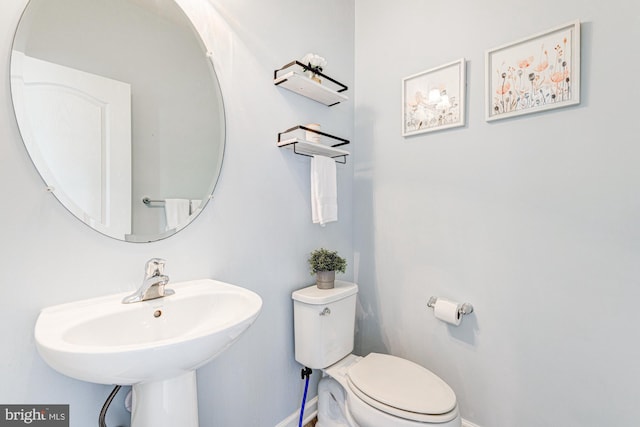 1303 Officers Row, Delaware City, DE 19706 - bathroom featuring baseboards, toilet, and a sink