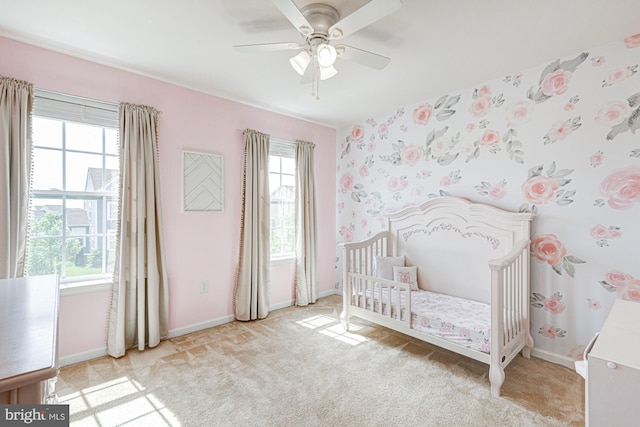 1303 Officers Row, Delaware City, DE 19706 - carpeted bedroom featuring a crib, baseboards, and ceiling fan