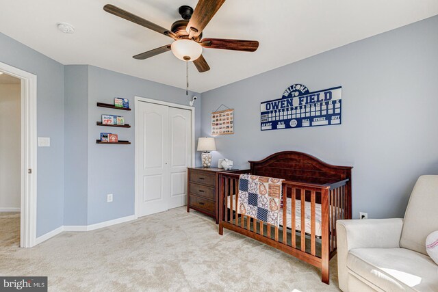 1303 Officers Row, Delaware City, DE 19706 - carpeted bedroom with a closet, baseboards, a ceiling fan, and a crib