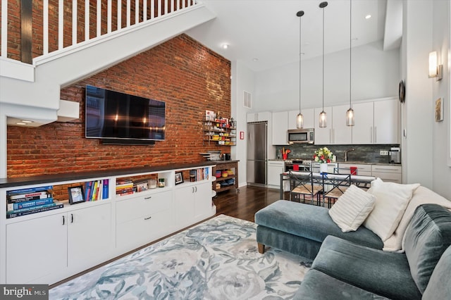 1113 Fitzwater St Unit A, Philadelphia, PA 19147 - living area with a high ceiling, dark wood-style floors, and brick wall
