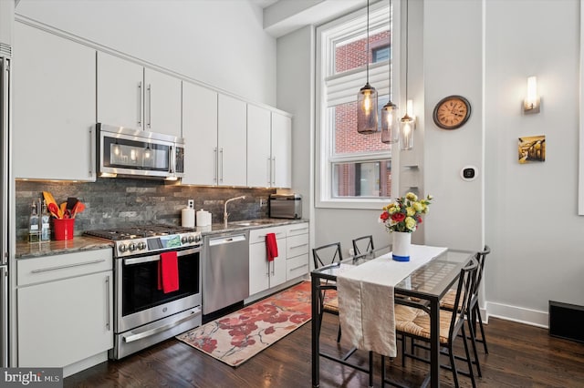 1113 Fitzwater St Unit A, Philadelphia, PA 19147 - kitchen featuring stainless steel appliances, backsplash, dark wood-style floors, a towering ceiling, and white cabinets