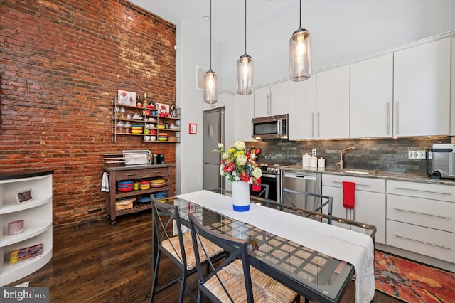 1113 Fitzwater St Unit A, Philadelphia, PA 19147 - kitchen featuring stainless steel appliances, dark wood finished floors, backsplash, a sink, and decorative light fixtures