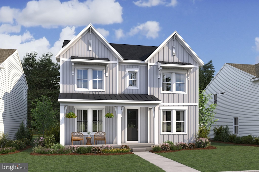 modern inspired farmhouse featuring board and batten siding, a porch, a standing seam roof, and a front lawn