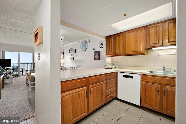 10002 Coastal Hwy Unit 611, Ocean City, MD 21842 - kitchen featuring dishwasher, a sink, light countertops, and brown cabinets