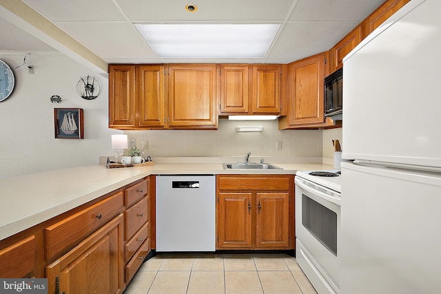 10002 Coastal Hwy Unit 611, Ocean City, MD 21842 - kitchen featuring white appliances, a sink, light tile patterned floors, light countertops, and brown cabinets
