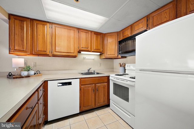 10002 Coastal Hwy Unit 611, Ocean City, MD 21842 - kitchen featuring white appliances, a sink, light tile patterned flooring, light countertops, and brown cabinetry