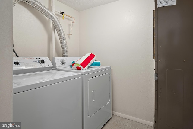 10002 Coastal Hwy Unit 611, Ocean City, MD 21842 - clothes washing area with independent washer and dryer, light tile patterned floors, and baseboards