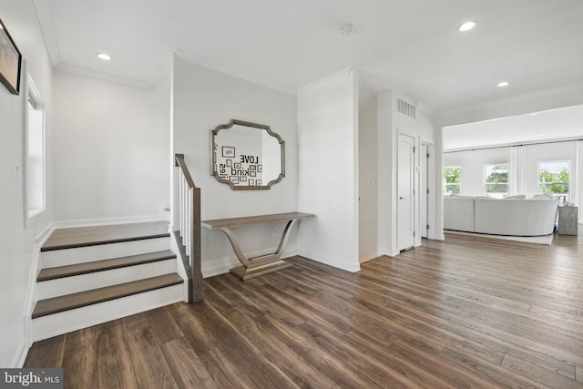 foyer with wood finished floors, stairs, ornamental molding, recessed lighting, and baseboards