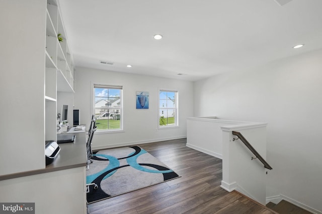 workout room with wood finished floors, baseboards, and recessed lighting
