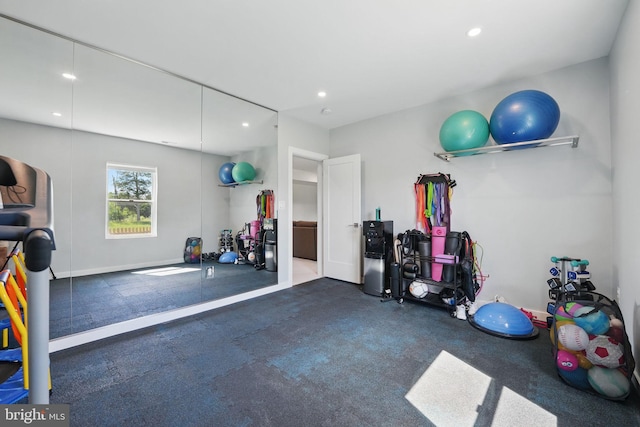 exercise area featuring recessed lighting and baseboards