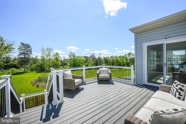 wooden terrace with a yard and view of scattered trees