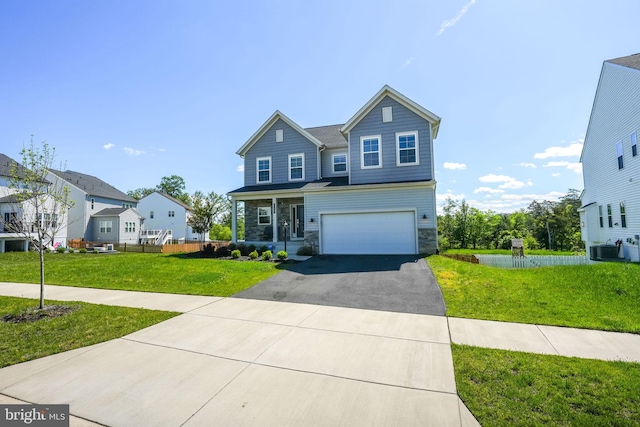 view of front facade with stone siding, driveway, a garage, and a front yard