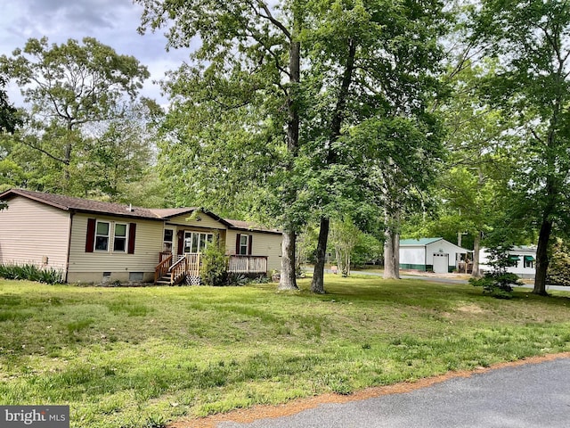 27846 Lord Calvert Dr, Millsboro, DE 19966 - manufactured / mobile home featuring a wooden deck, a front yard, crawl space, and a garage