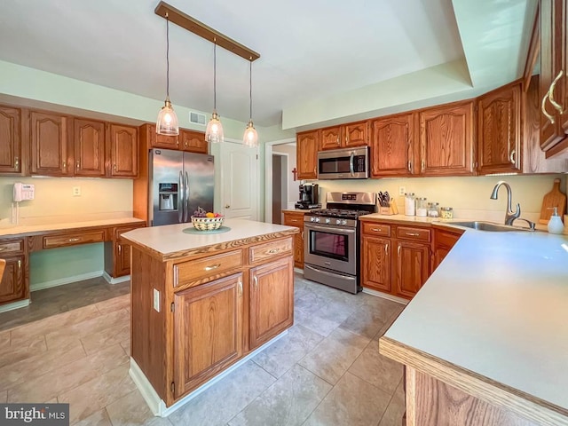 kitchen featuring appliances with stainless steel finishes, a sink, a center island, light countertops, and brown cabinets