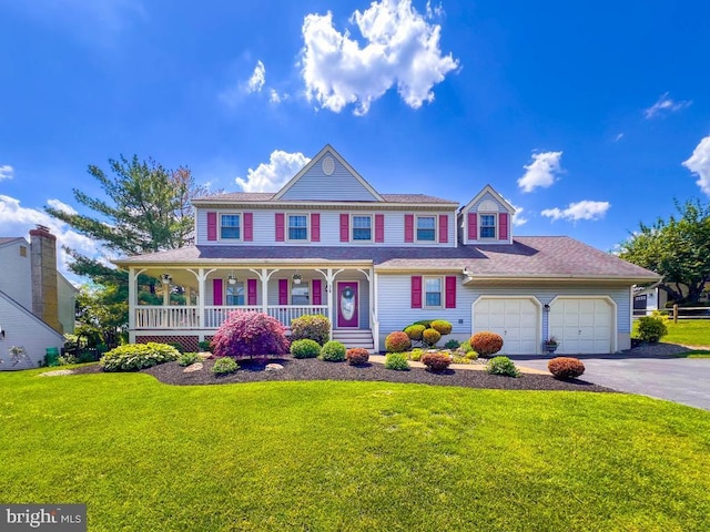 view of front of home featuring covered porch, asphalt driveway, a front lawn, and an attached garage