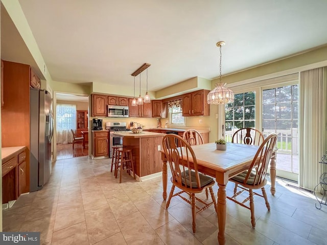 dining area featuring a chandelier and light tile patterned floors