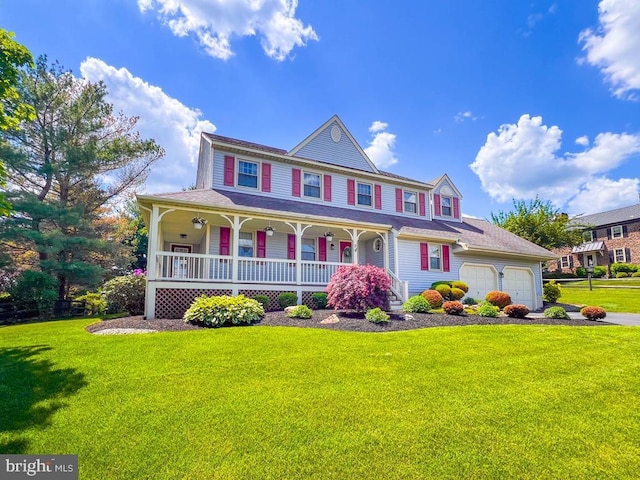 victorian-style house with a porch, a front yard, a garage, and driveway