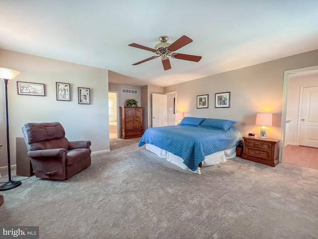 bedroom featuring carpet flooring, baseboards, a ceiling fan, and ensuite bathroom