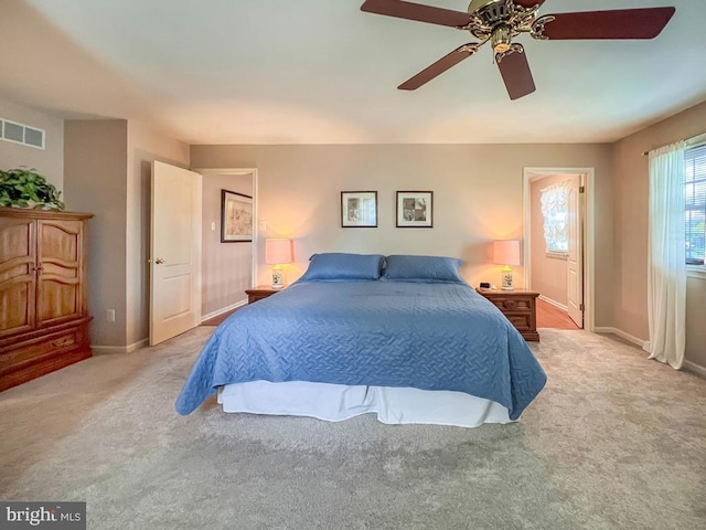 bedroom with light carpet, baseboards, and ceiling fan