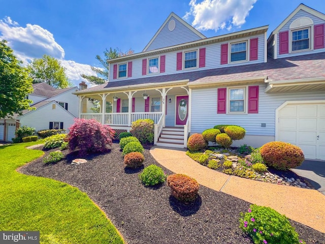 view of front of house featuring covered porch and a garage