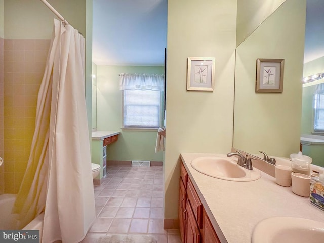 full bathroom featuring double vanity, tile patterned flooring, shower / bath combo, and toilet