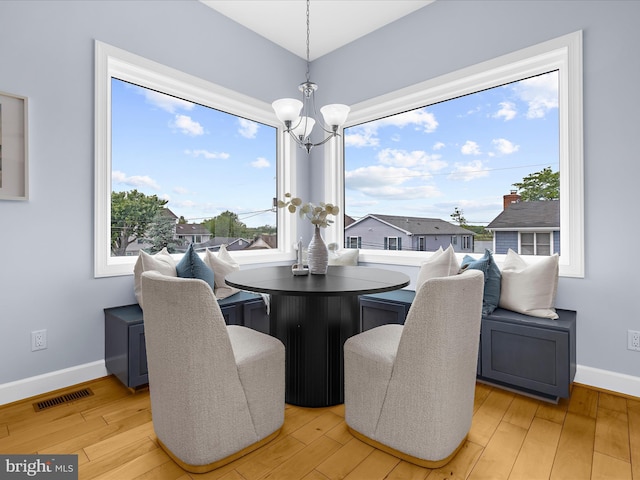 7839 Denton Ave, Baltimore, MD 21219 - dining space featuring a chandelier, baseboards, and light wood finished floors