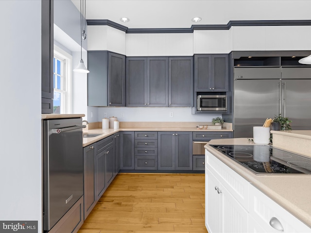 7839 Denton Ave, Baltimore, MD 21219 - kitchen featuring built in appliances, light wood-type flooring, light countertops, hanging light fixtures, and recessed lighting